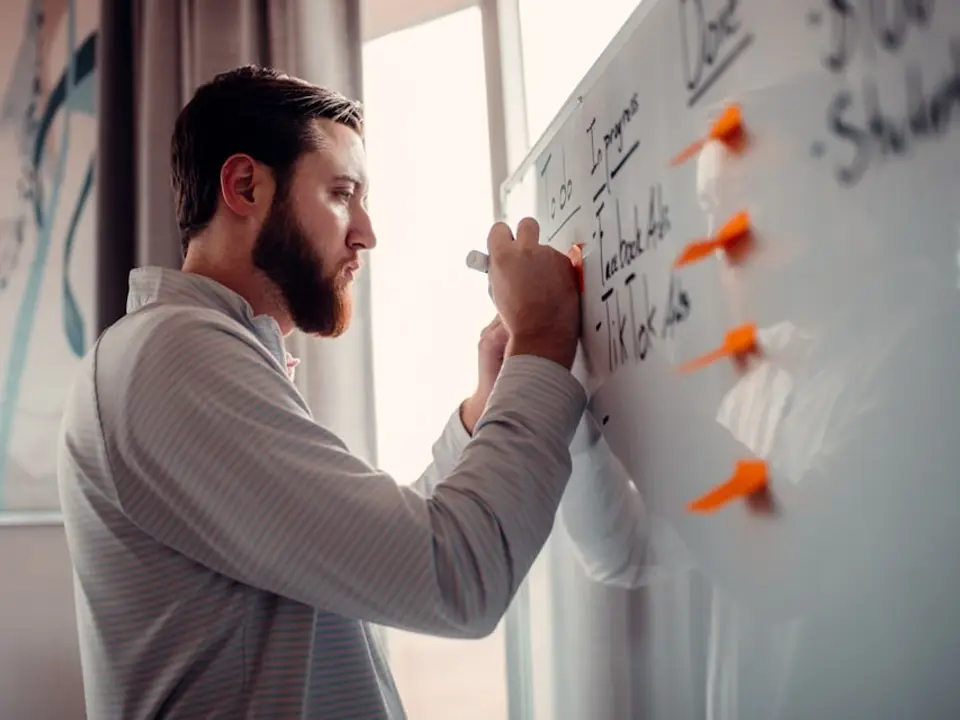 Facilitator writing on a whiteboard