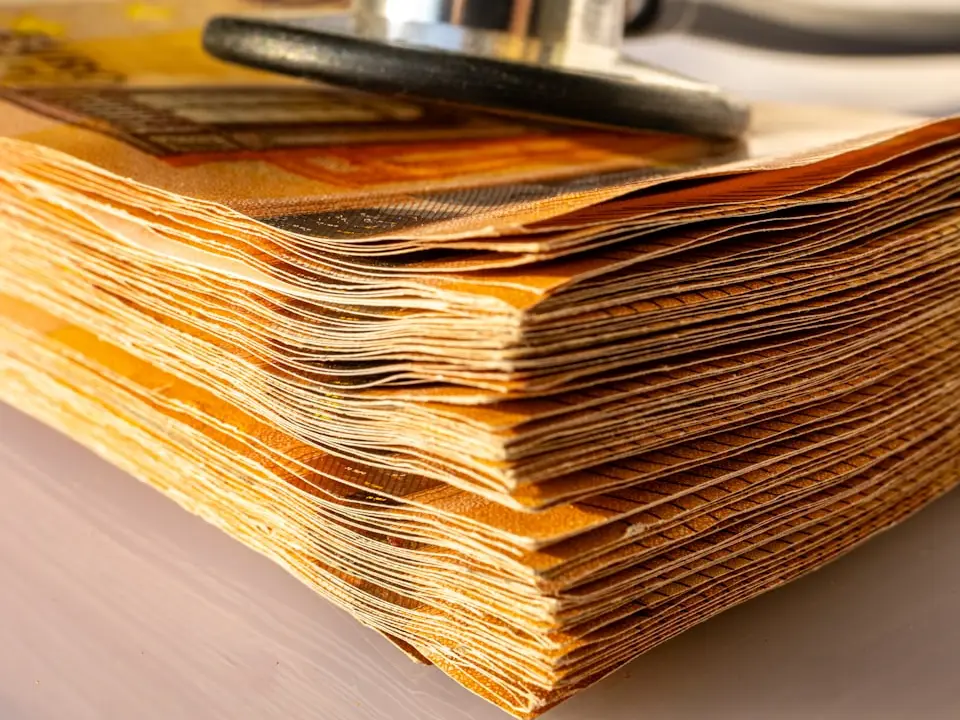 Stethoscope on a stack of paper records